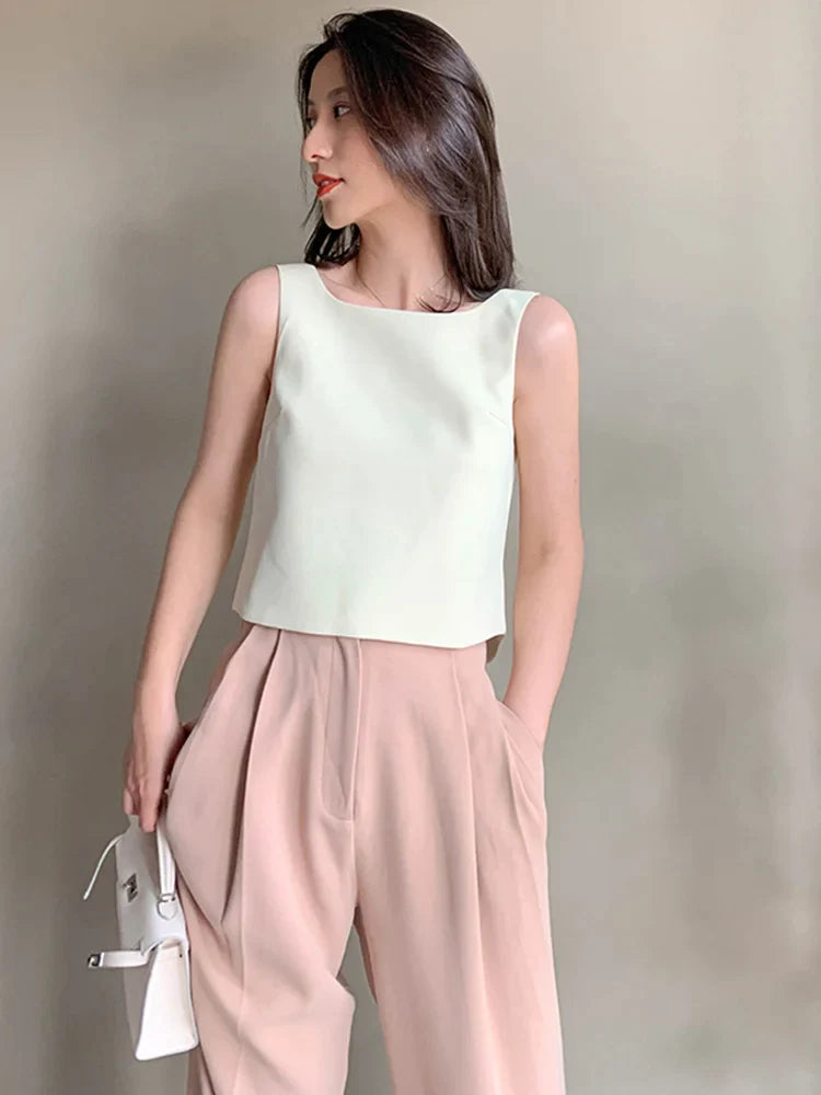EAM-Women-White-Backless-Pleated-Irregular-Tank-Tops-New-O-collar-Sleeveless-Personality-Fashion-Spring_377afe8d-4b56-426d-b84f-35a46a787e6d.webp